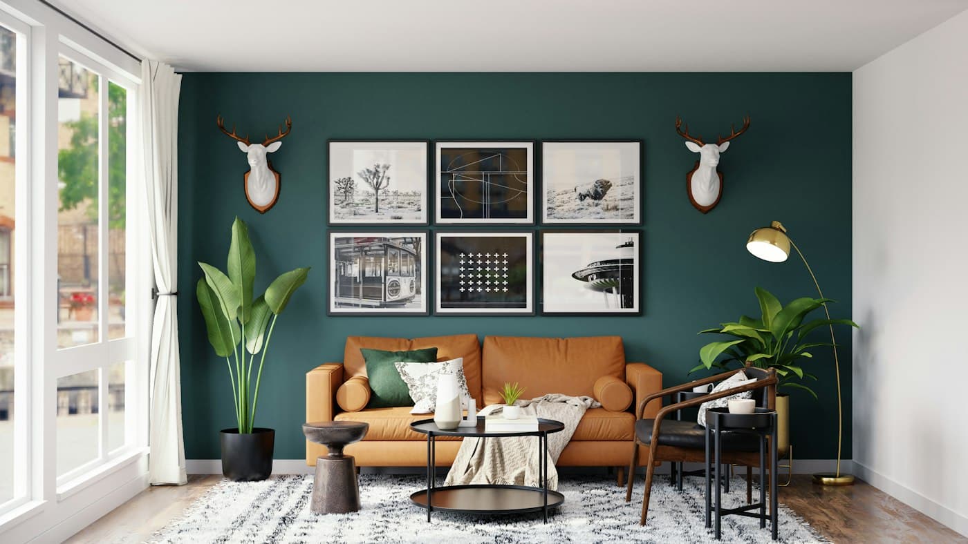 Living room with a teal feature wall and a tan leather sofa