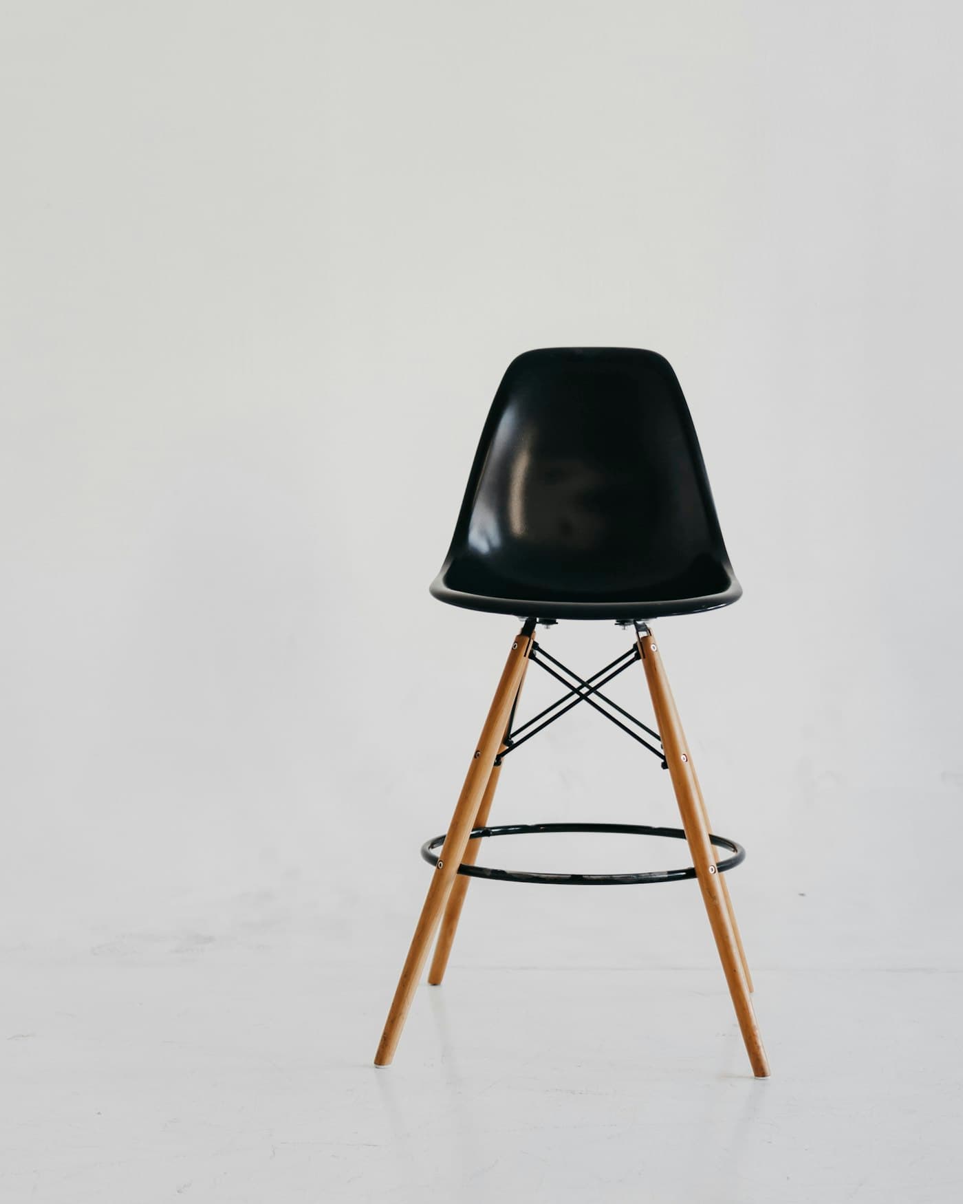 Counter stool with a black seat and oak legs