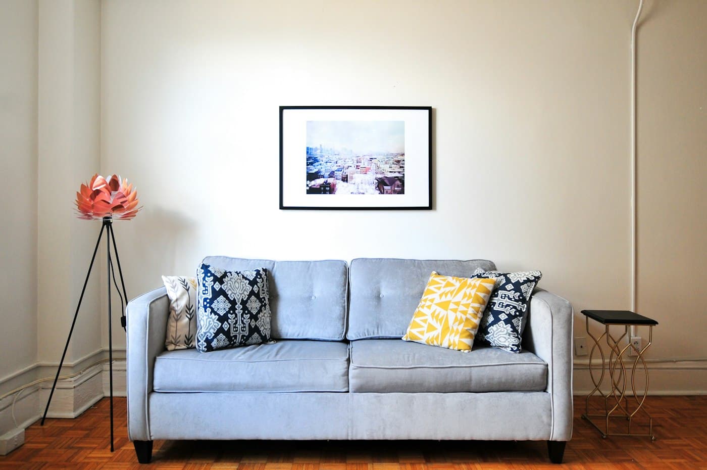 Living room wall styled with a framed print above the sofa