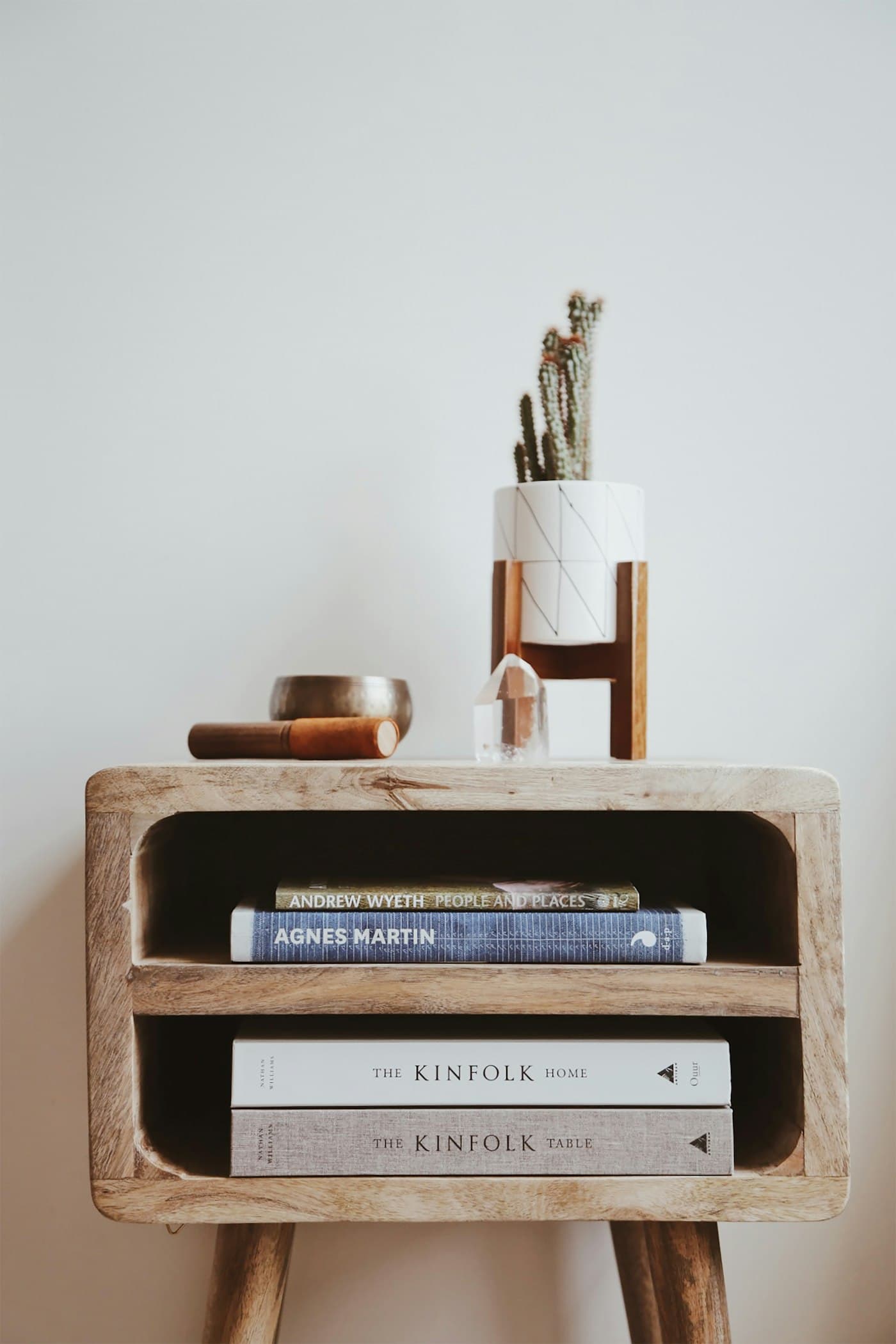 Close-up of oak open storage with books and a plant