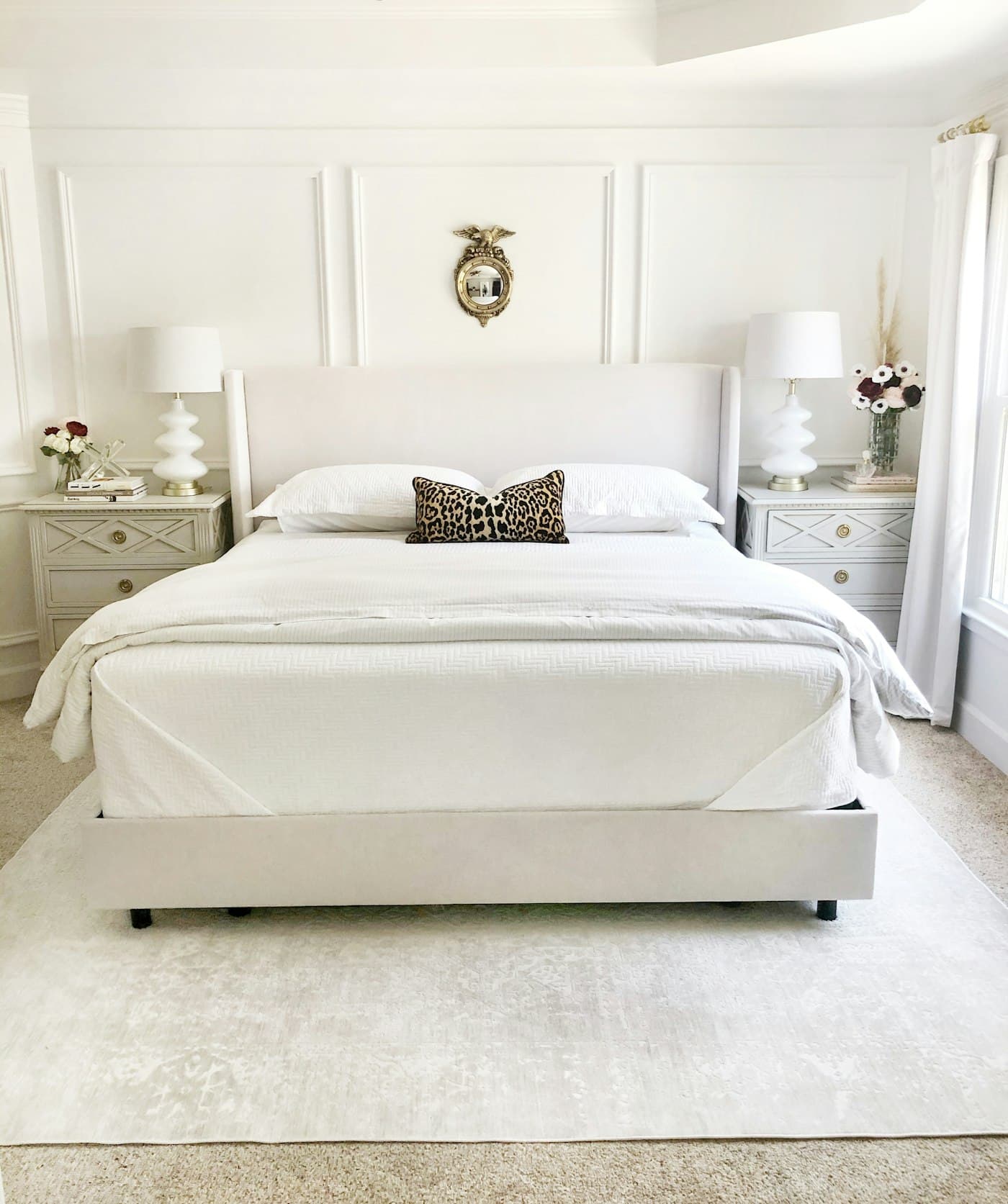 Serene bedroom with a white upholstered bed and panelled walls