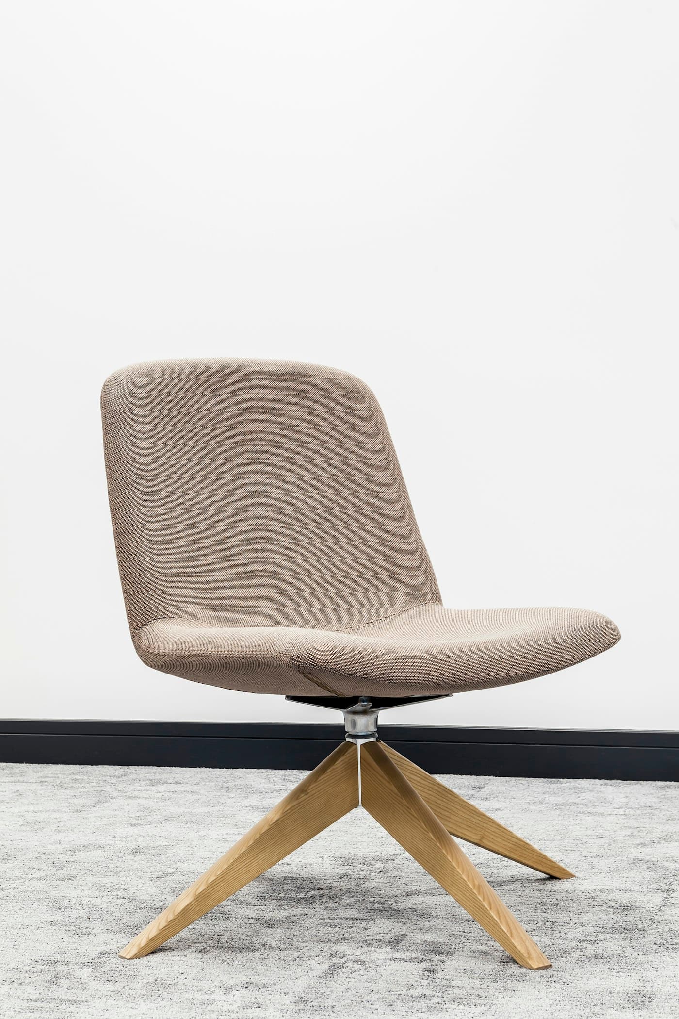 Upholstered dining chair on a light oak swivel base