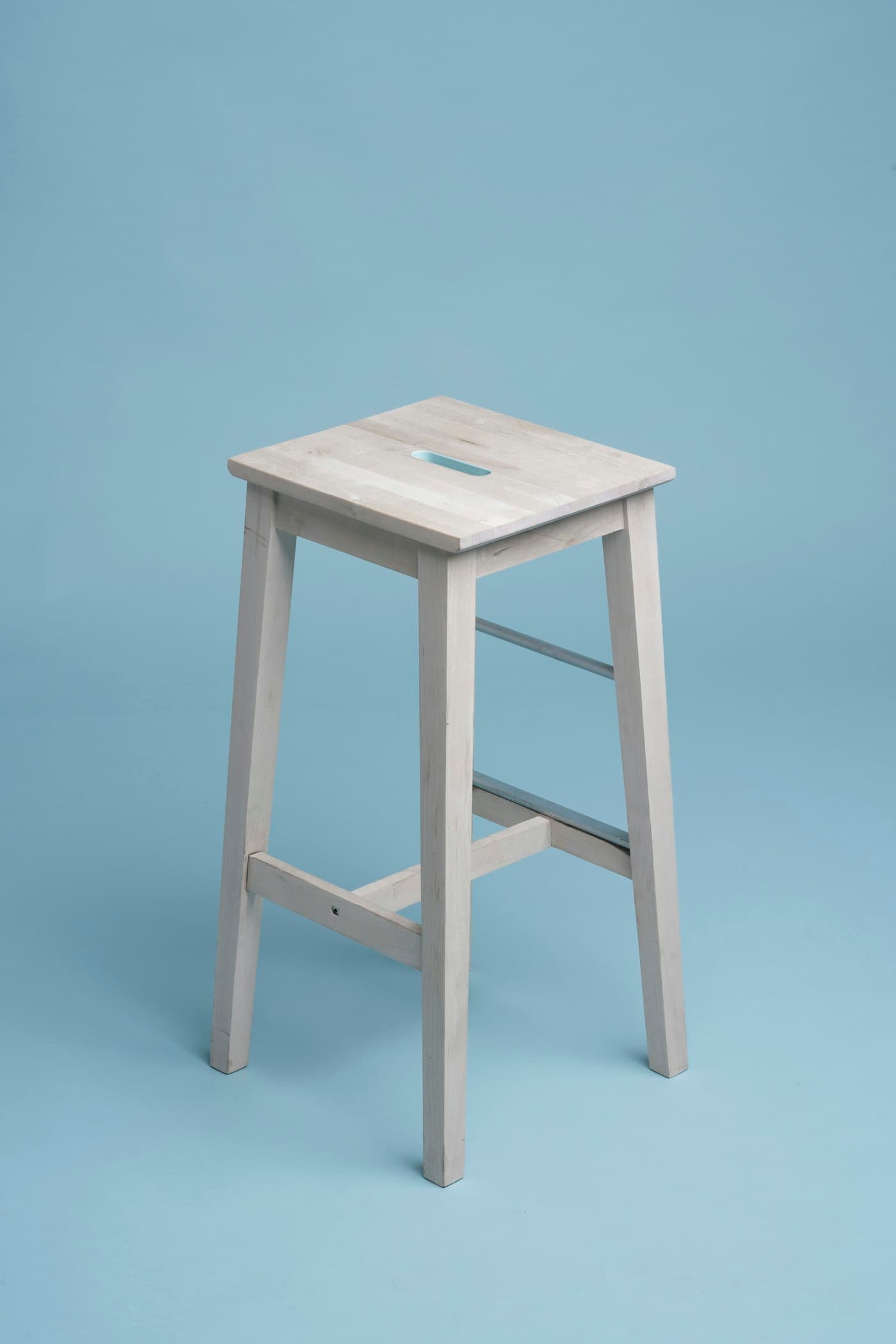 Pale ash wood bar stool with a footrest